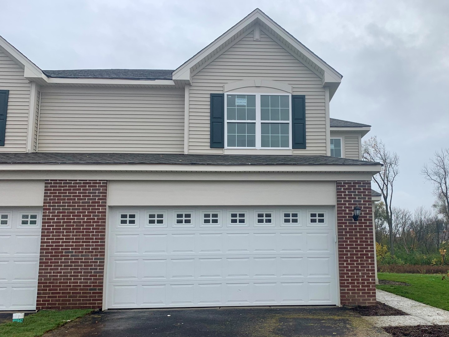 a front view of a house with garage