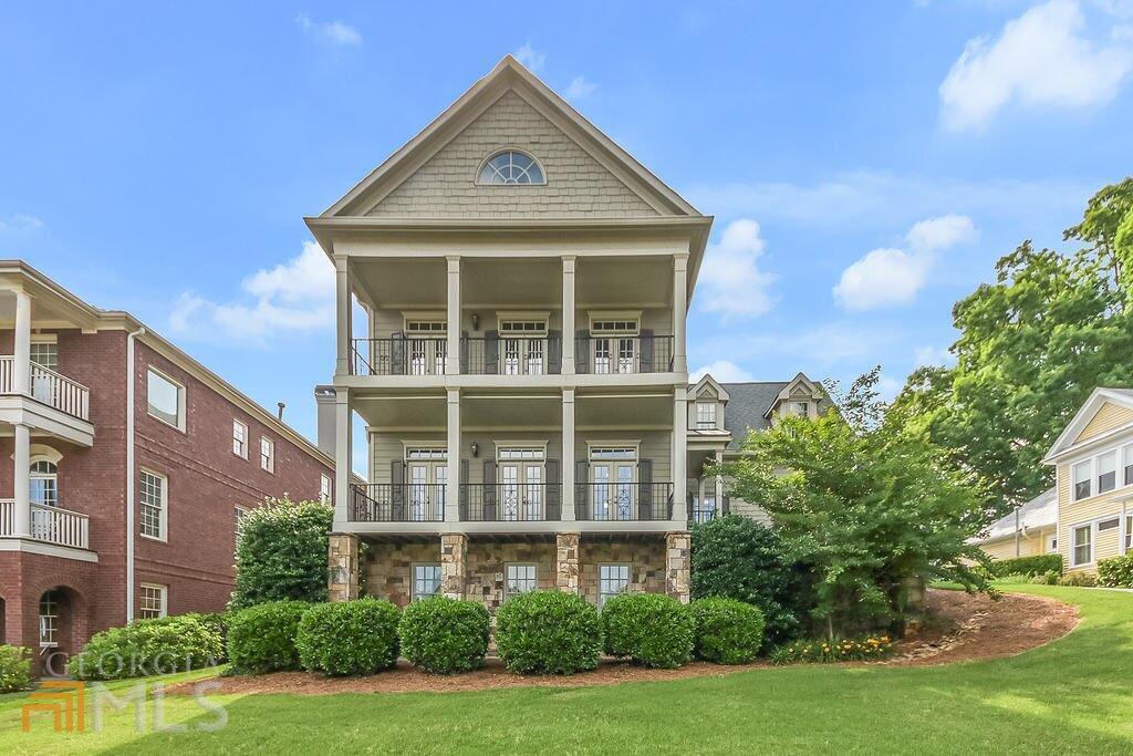 a front view of a residential apartment building with a yard