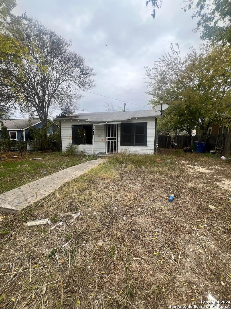 a front view of house with yard and trees around