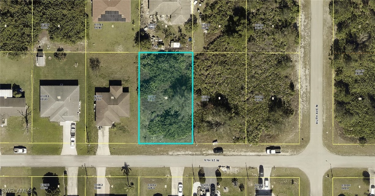 an aerial view of a residential apartment building with a yard