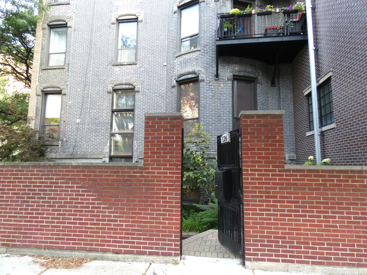 a view of a brick building next to a yard