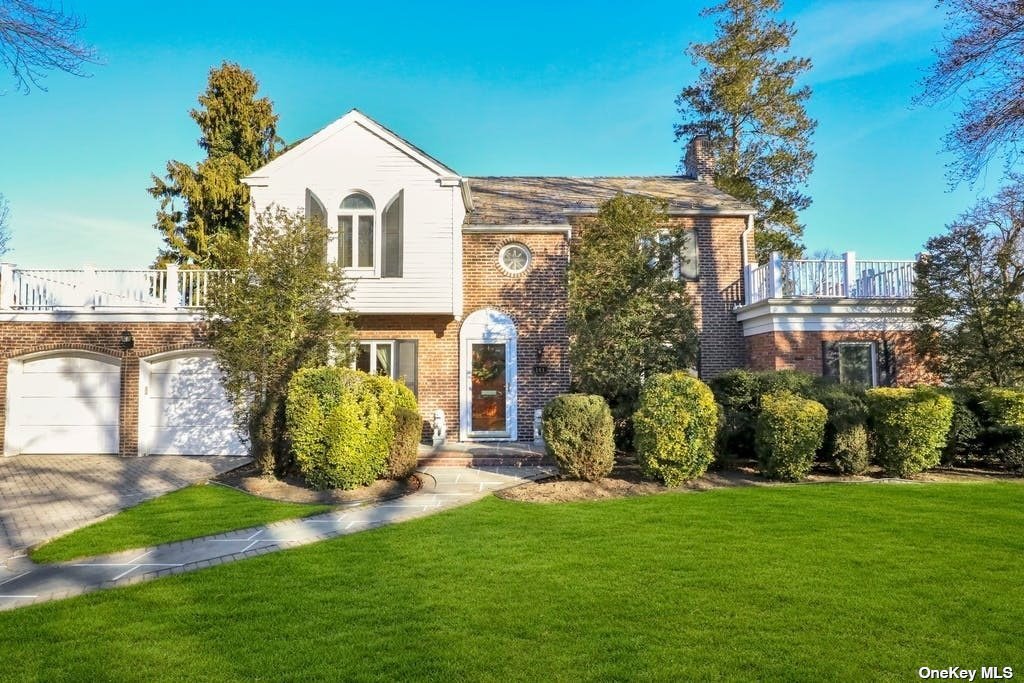 a front view of a house with a garden