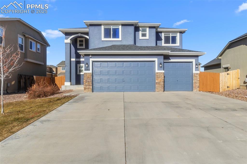 a front view of a house with a yard and garage