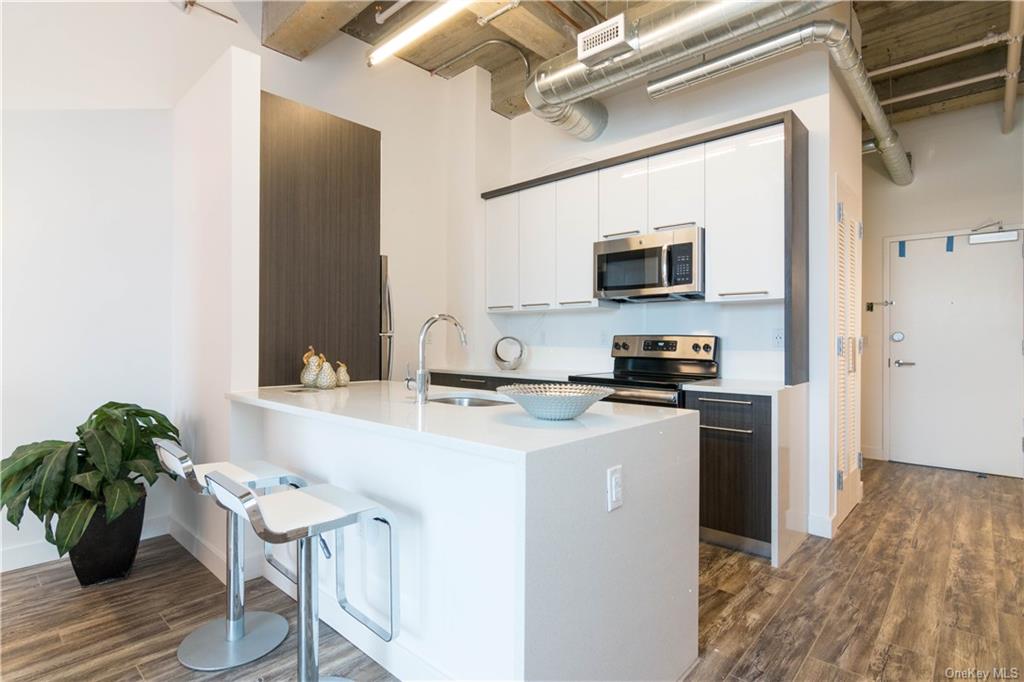 a kitchen with a sink cabinets and a stove