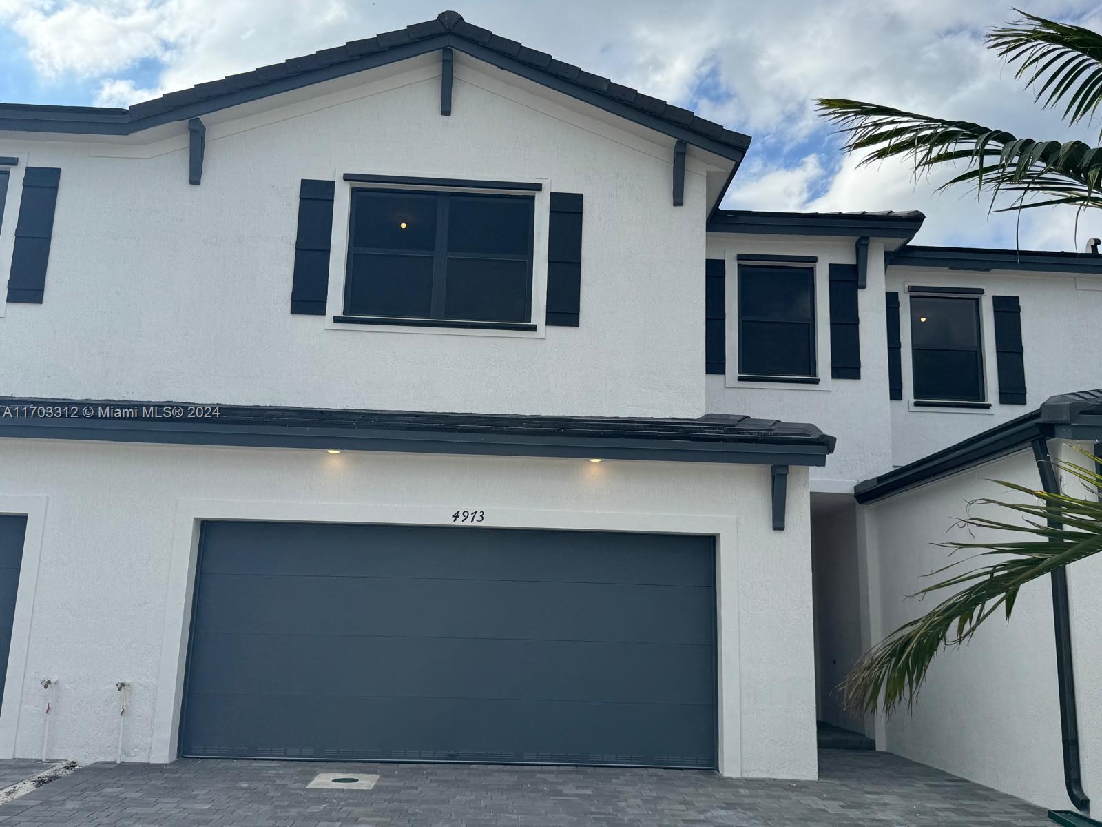 a front view of a house with a garage