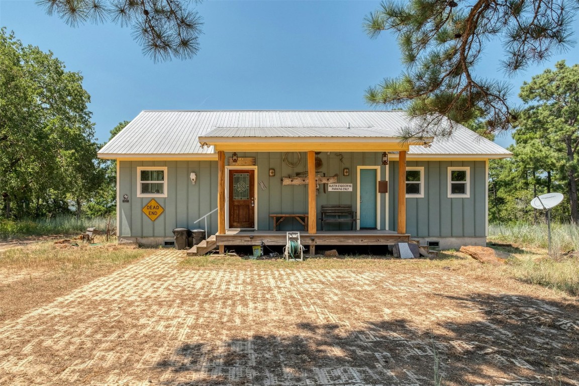 a view of the house with backyard porch and sitting area