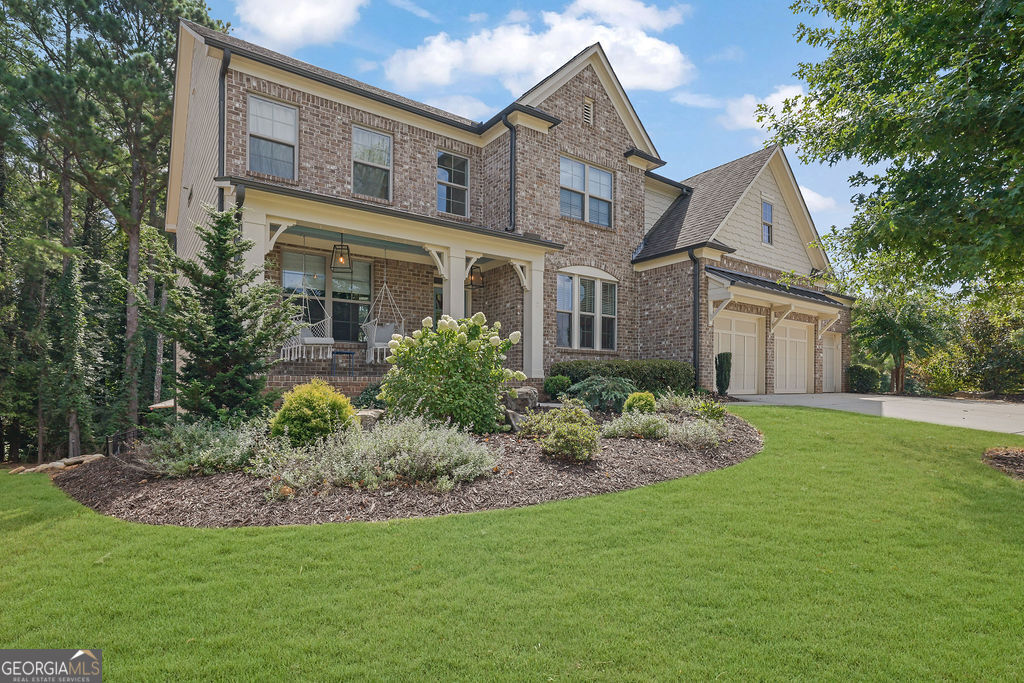 a front view of a house with a garden