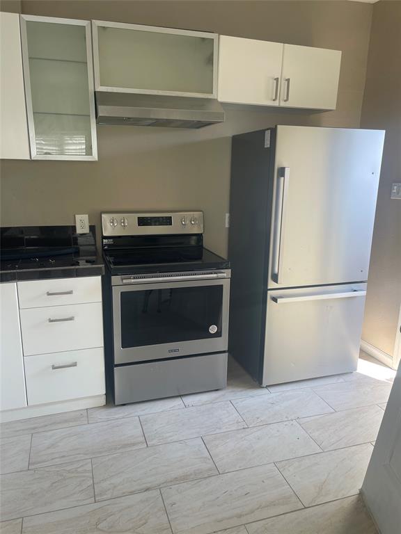 a kitchen with stainless steel appliances a stove and a refrigerator