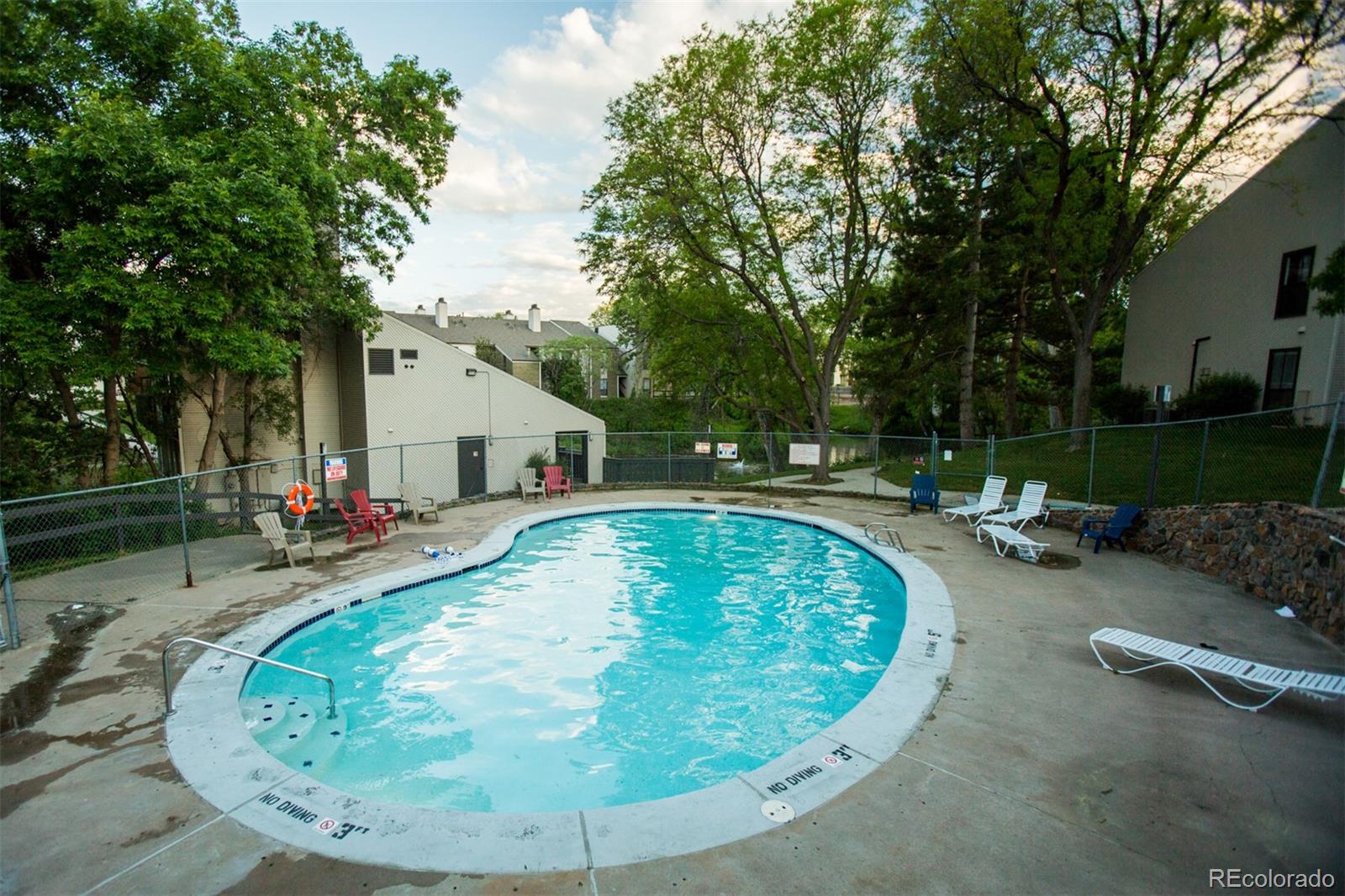 an outdoor view with a swimming pool and sitting area