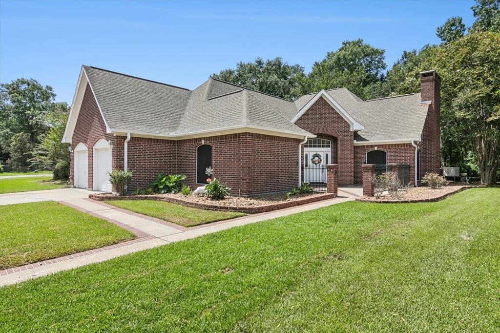 a front view of a house with a garden and patio