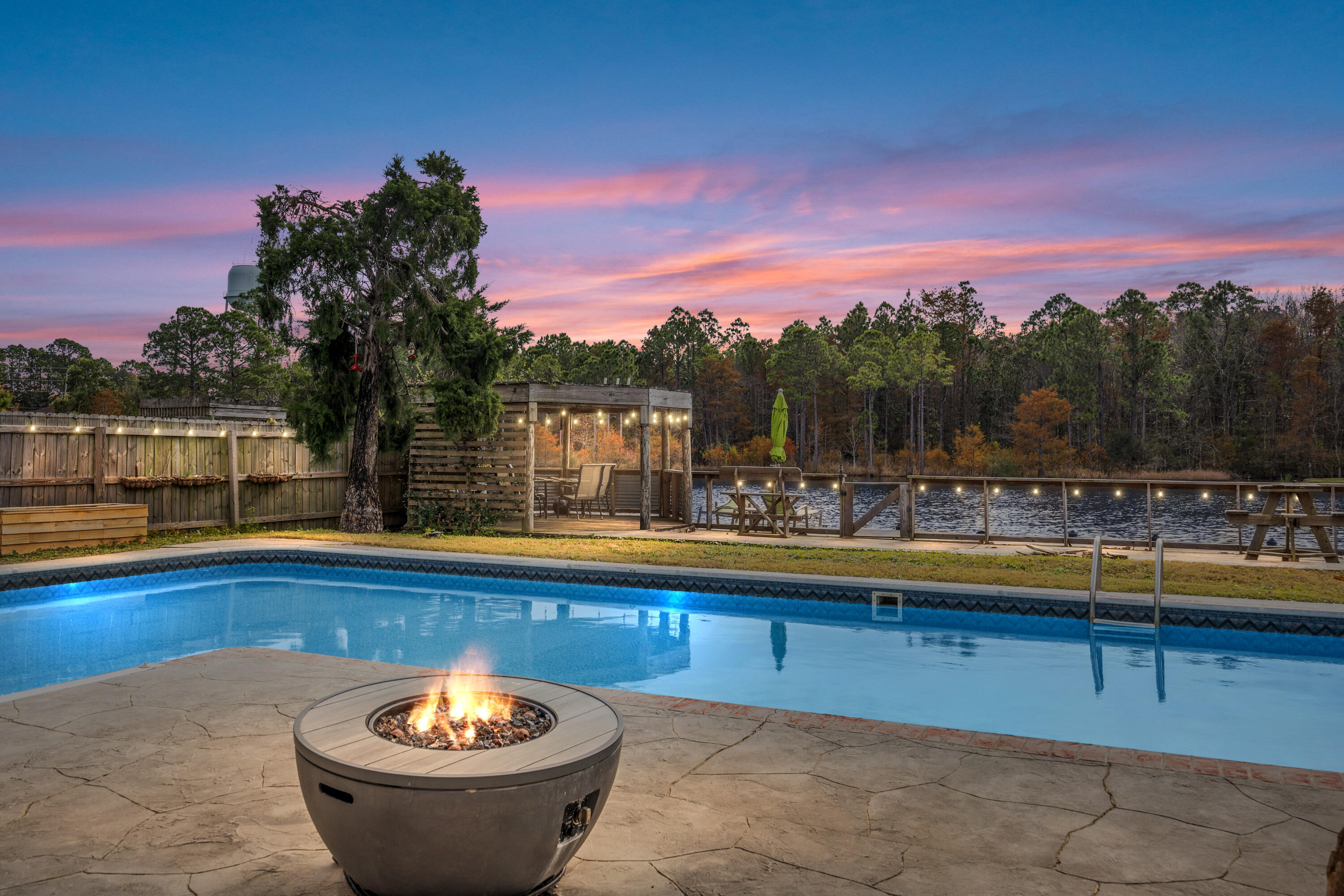 a view of a swimming pool with a table and chairs