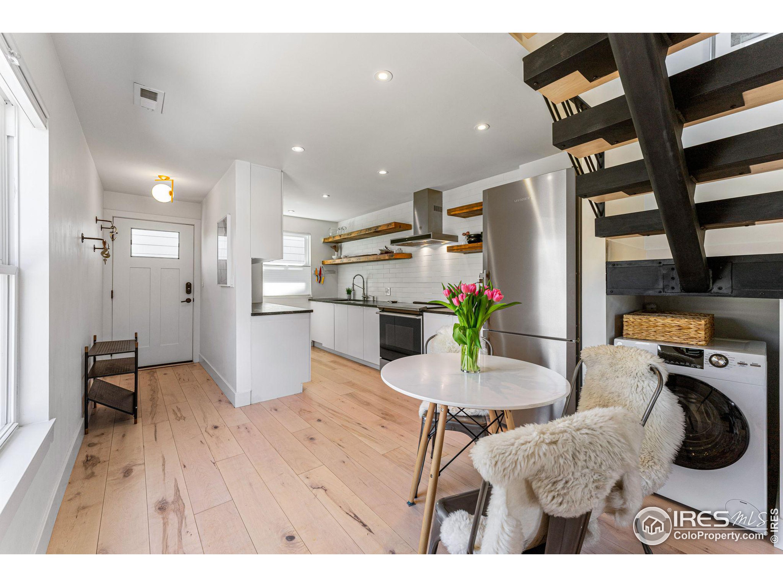 a living room with furniture and kitchen view