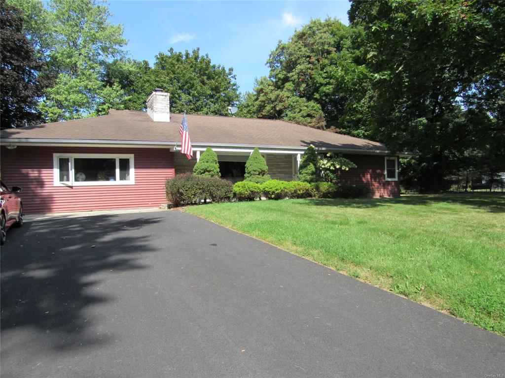 Single story home featuring a front lawn