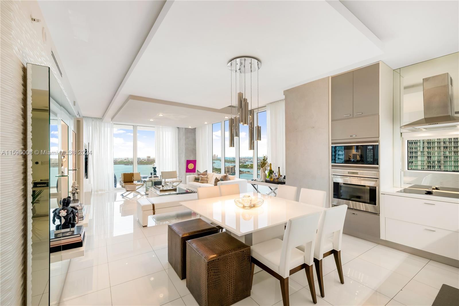 a large kitchen with a table chairs refrigerator and cabinets