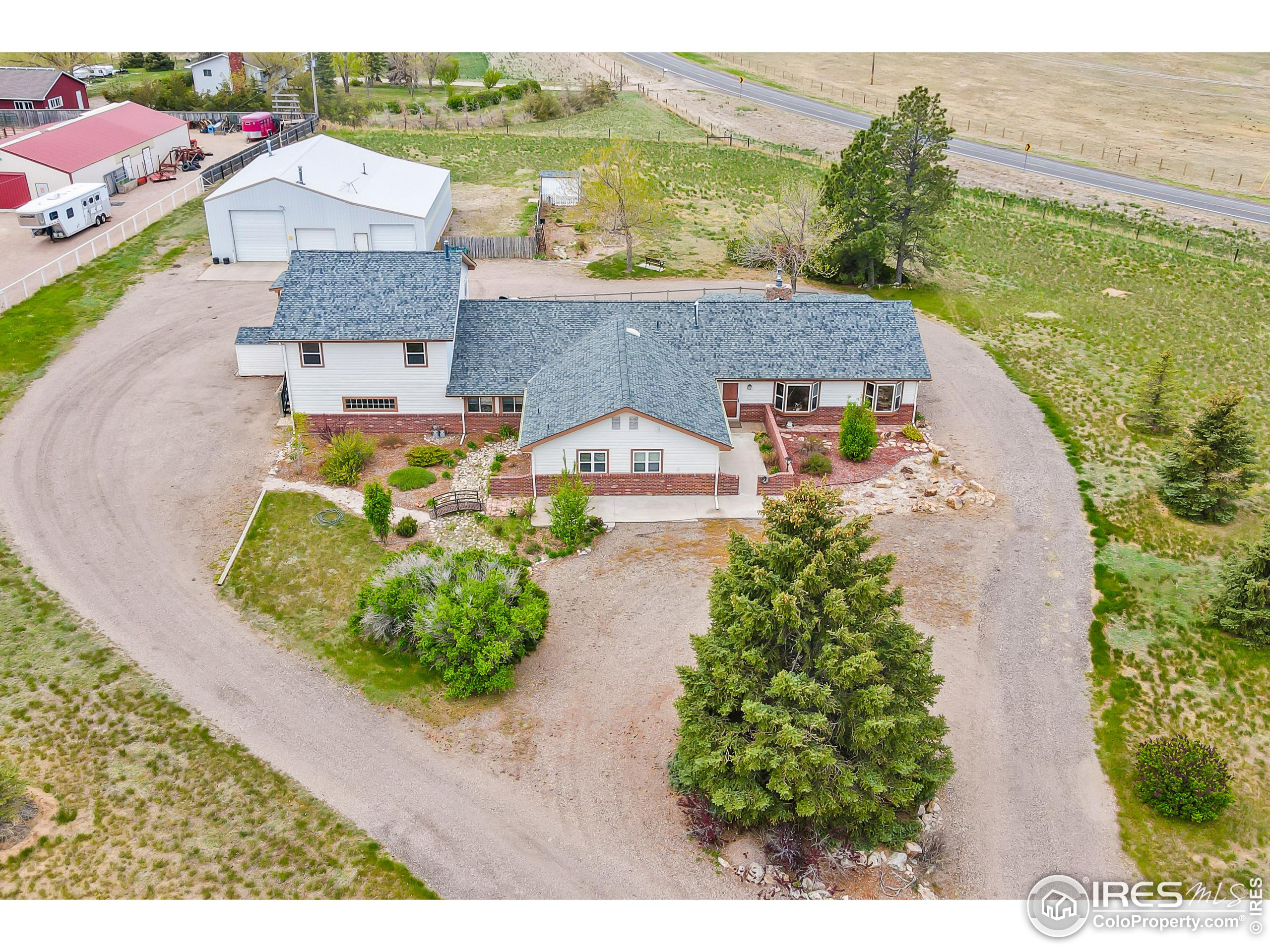 an aerial view of a house with a garden and lake view