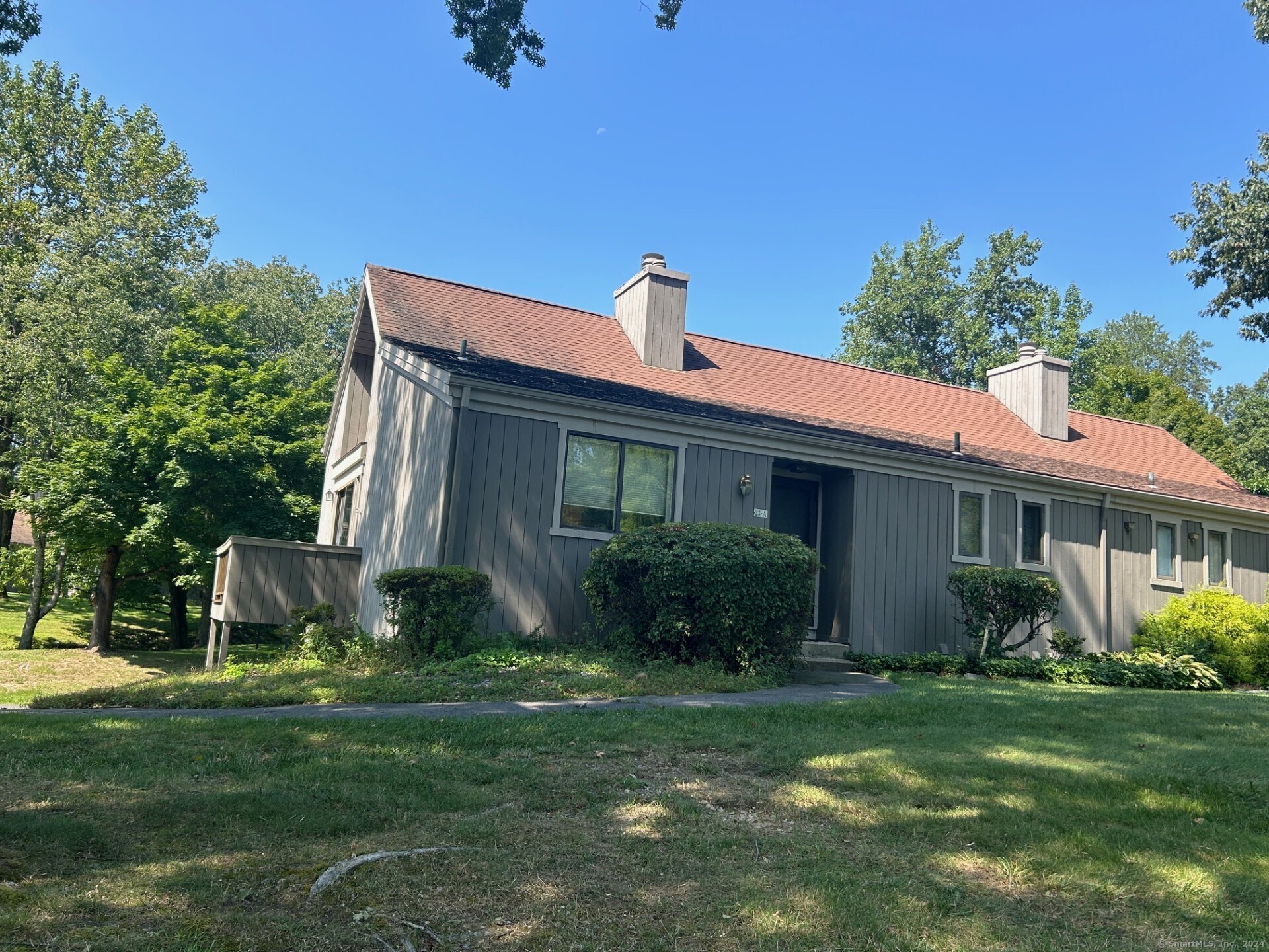 a front view of house with yard and green space