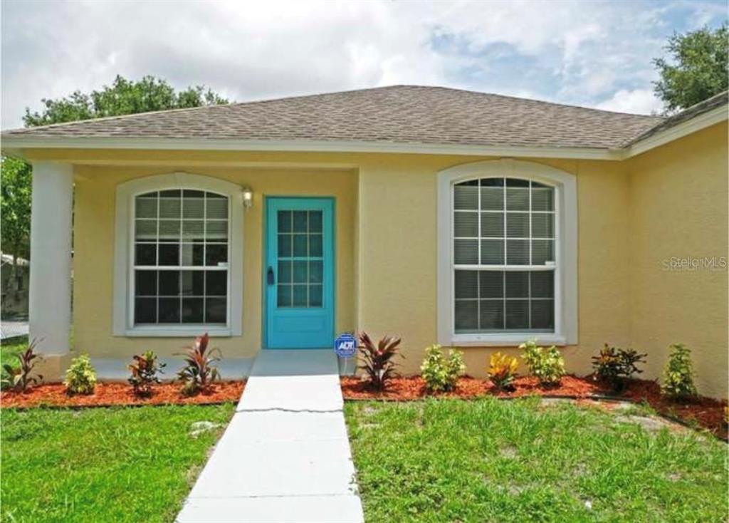 a front view of a house with a garden