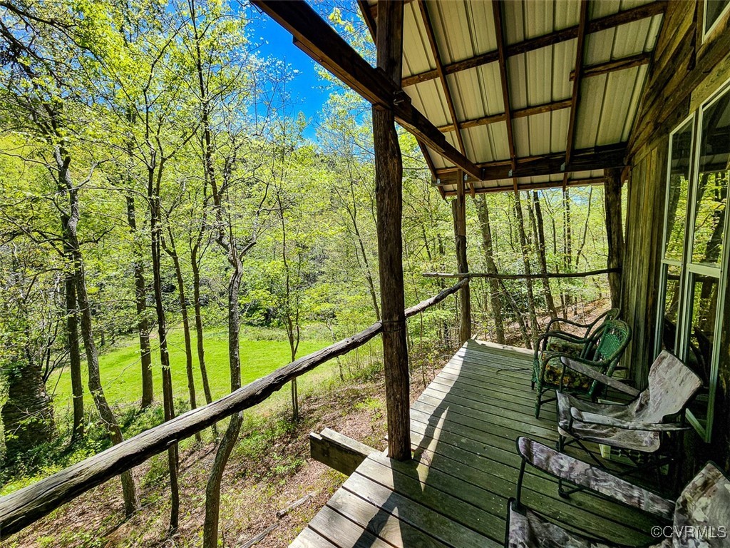 a view of trees and deck in the balcony