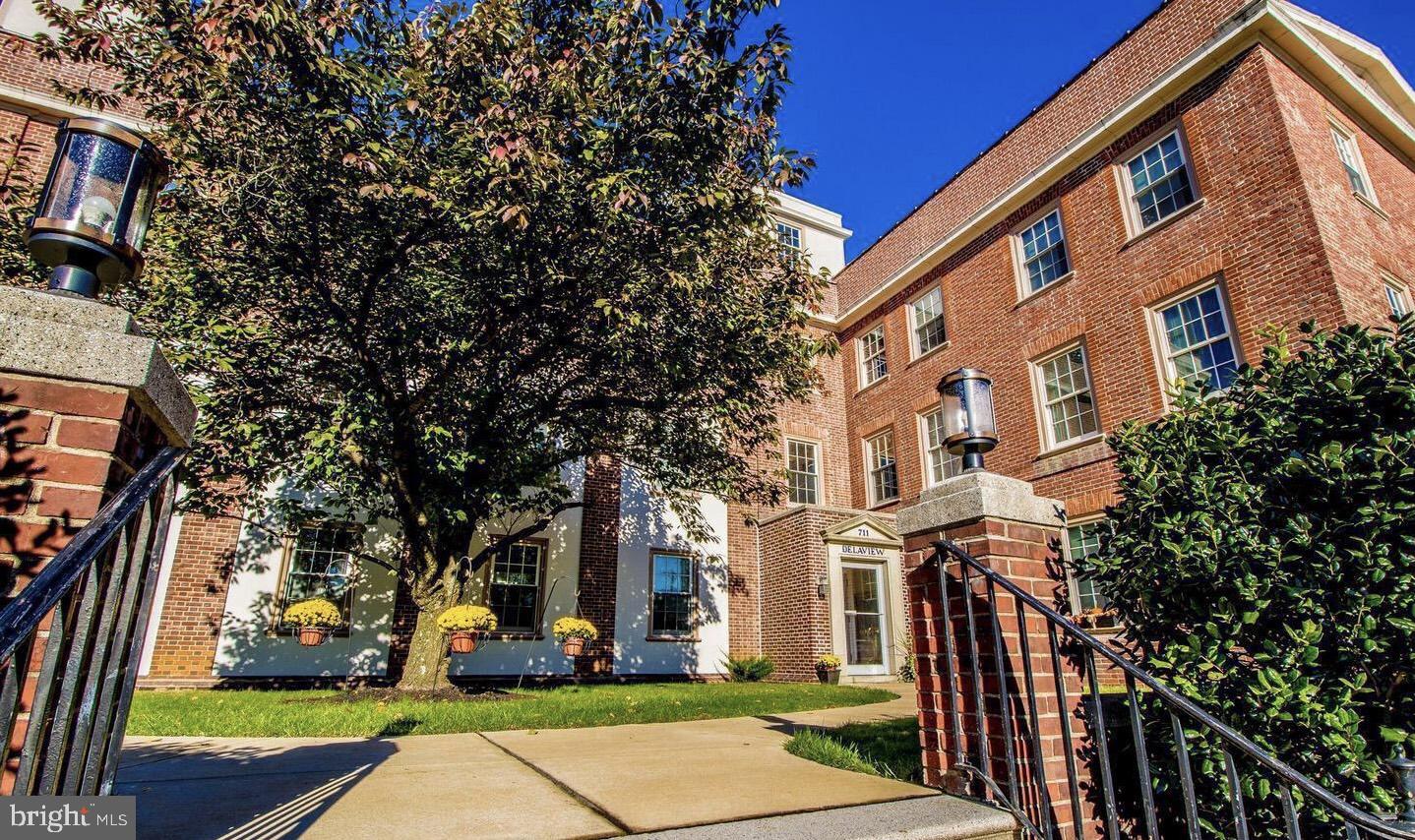 a view of a building with a yard