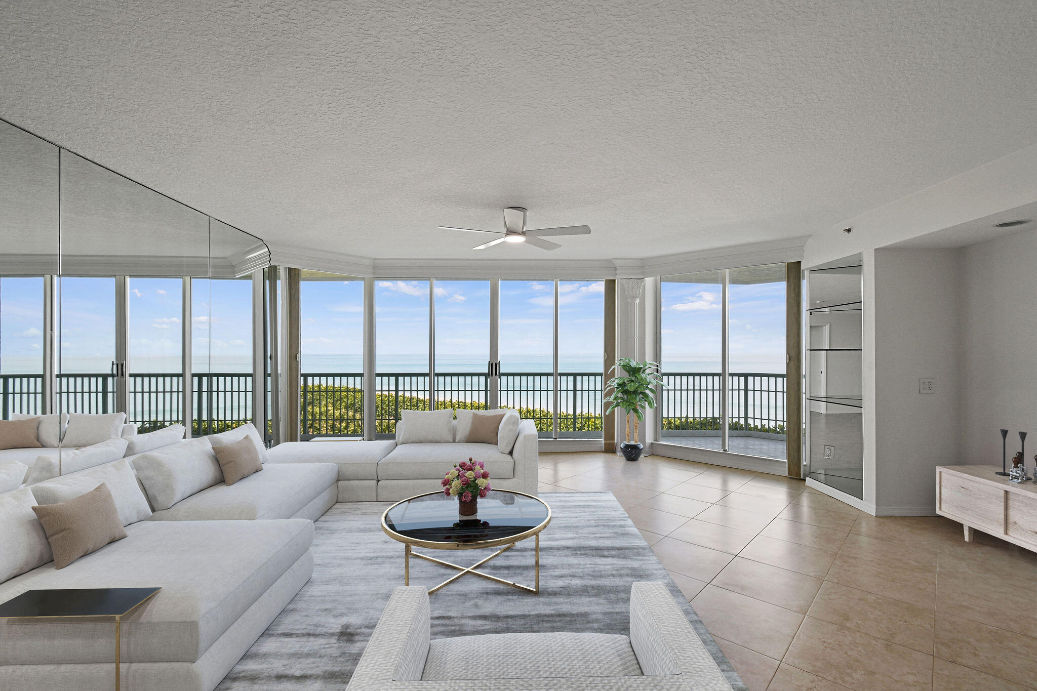 a living room with furniture and a floor to ceiling window