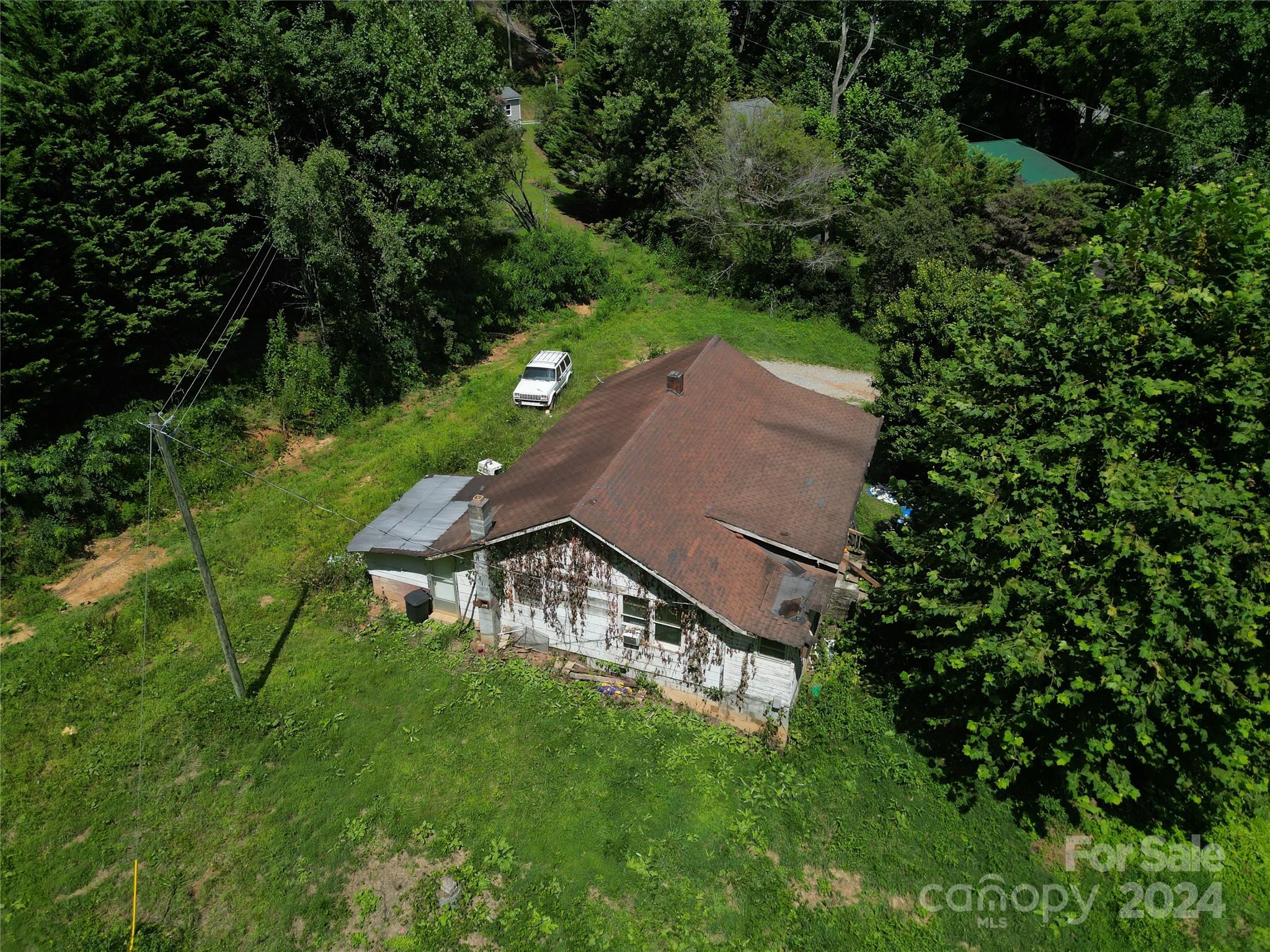 an aerial view of a house with a yard table and chairs