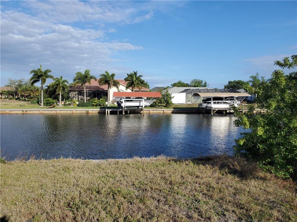 a view of a lake with boats and large trees