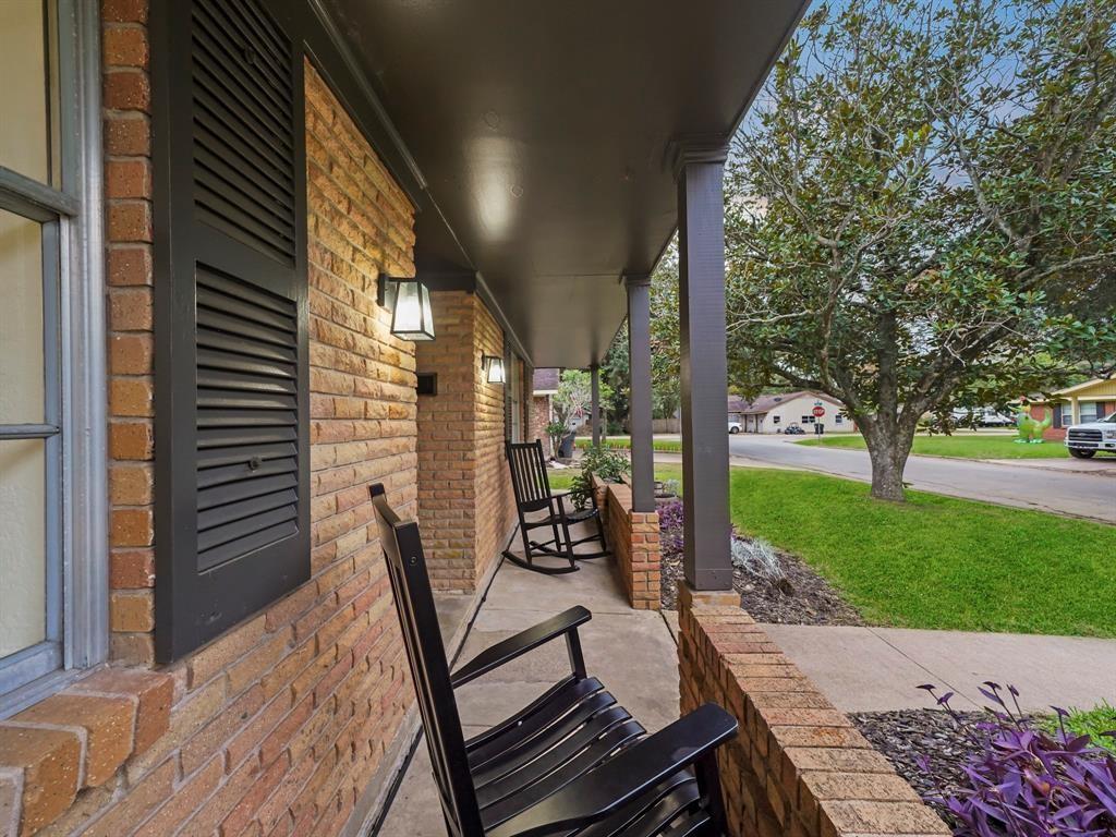 a view of a patio with a table chairs and a backyard