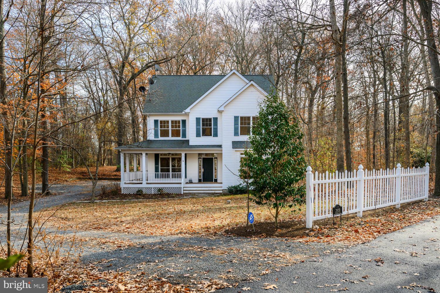 a front view of a house with a yard garage and outdoor seating