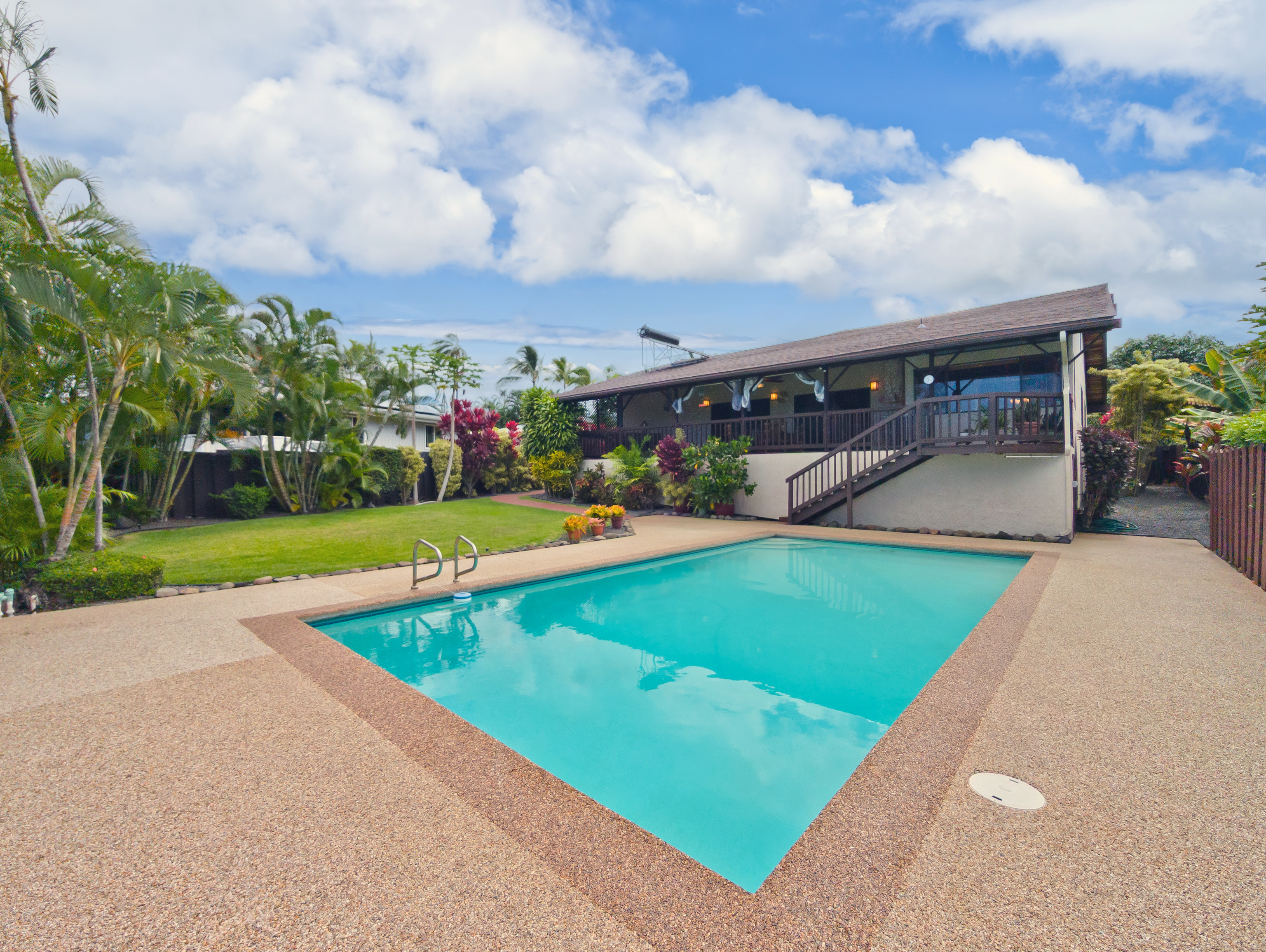 a view of a backyard with a patio and a garden