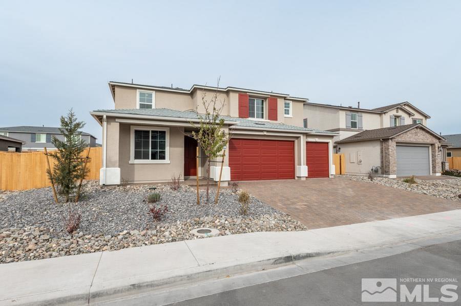 a view of a house with a yard and large parking space