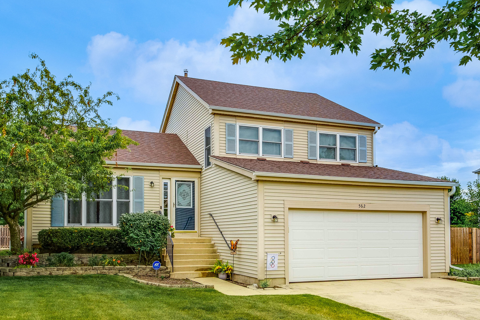 a front view of a house with garden