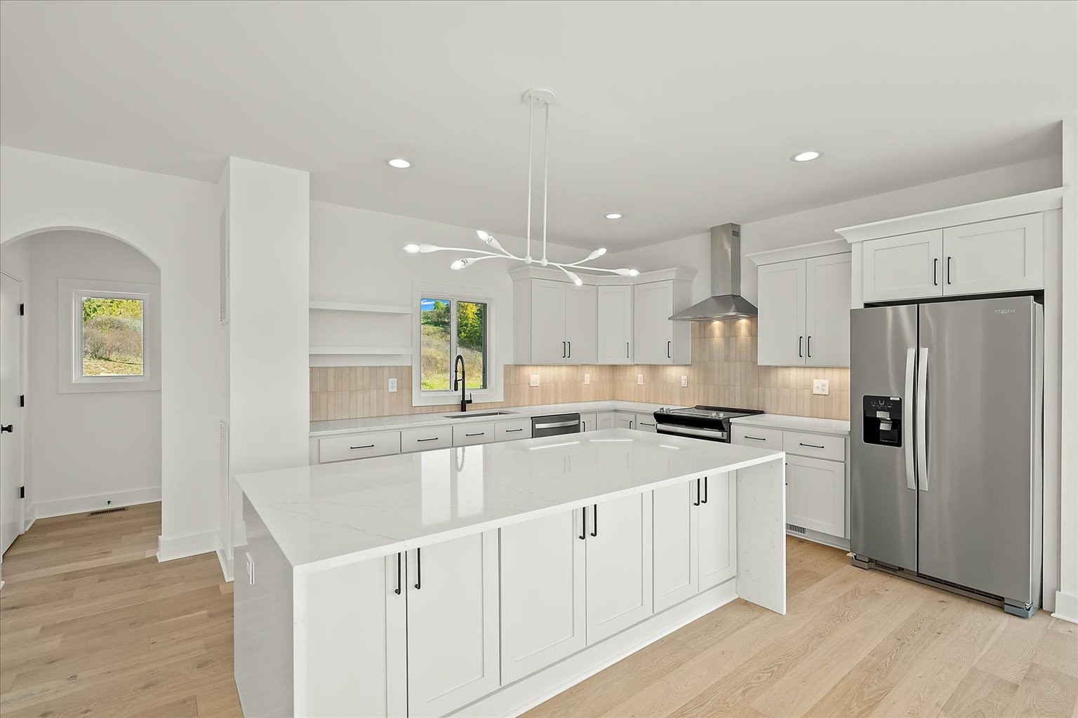 a kitchen with a sink a refrigerator and a stove