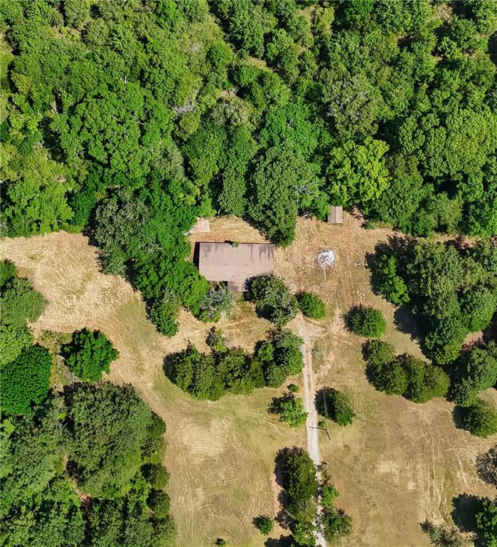 an aerial view of a house with yard