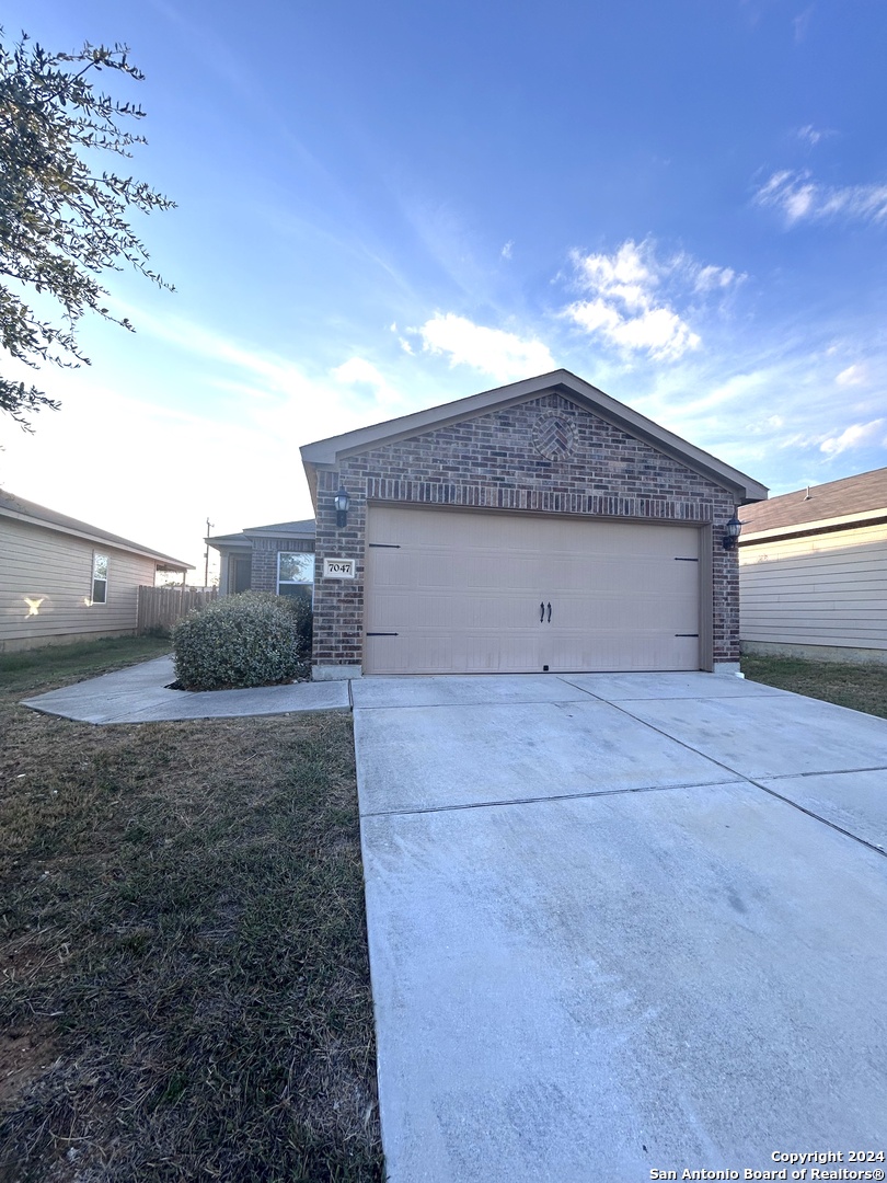 a view of a house with a yard and garage