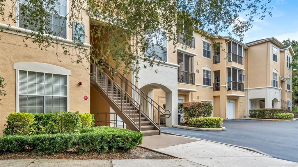 a front view of a multi story residential apartment building with a yard