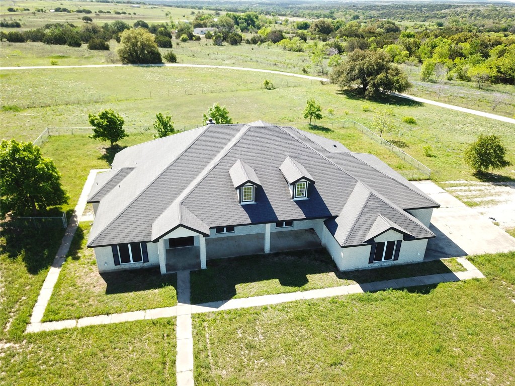 a aerial view of a house with a yard and lake view