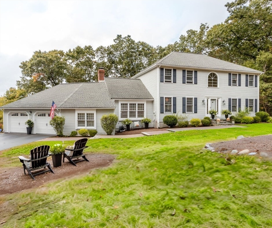 a view of a house with backyard sitting area and swimming pool