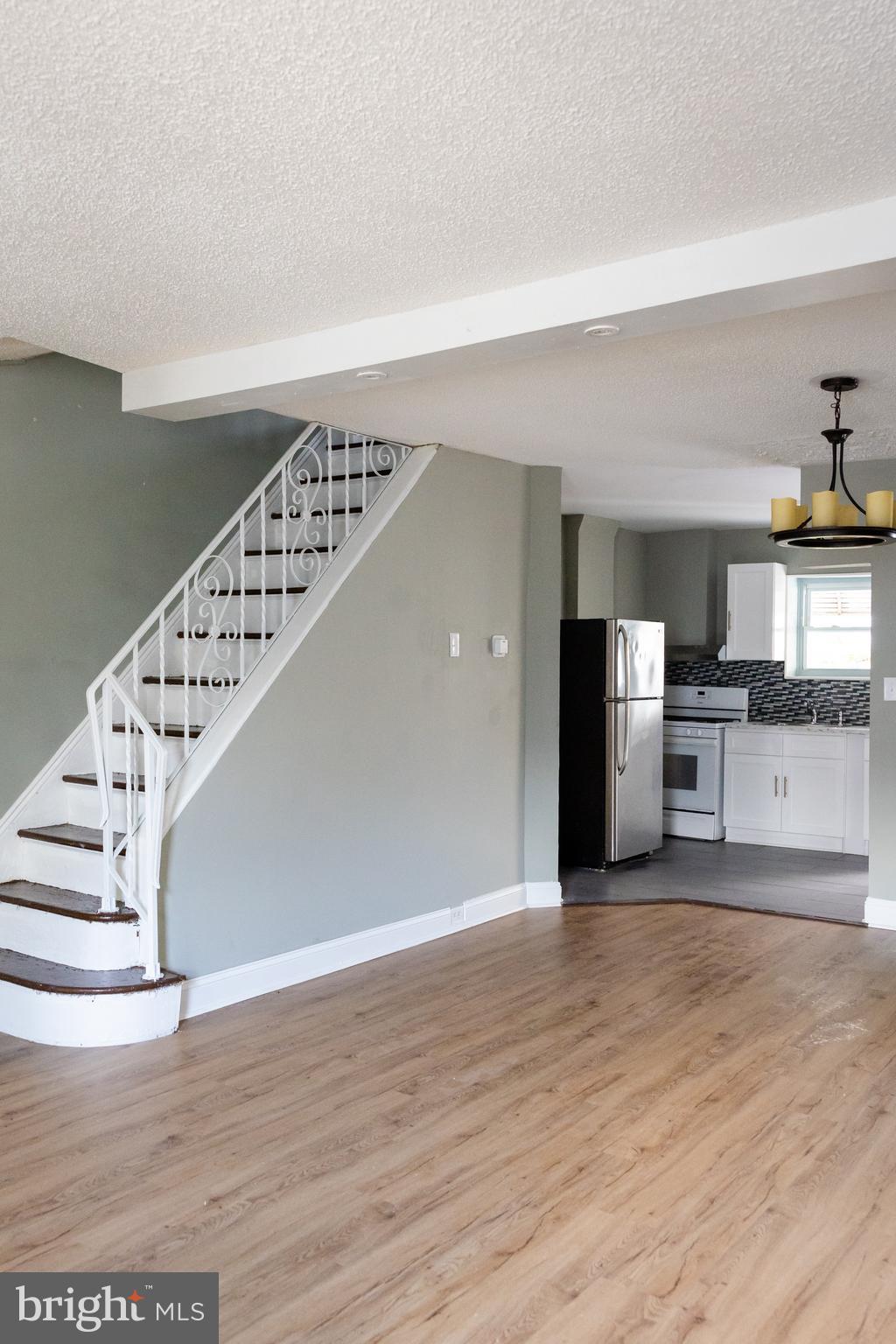 a view of kitchen with cabinets and wooden floor