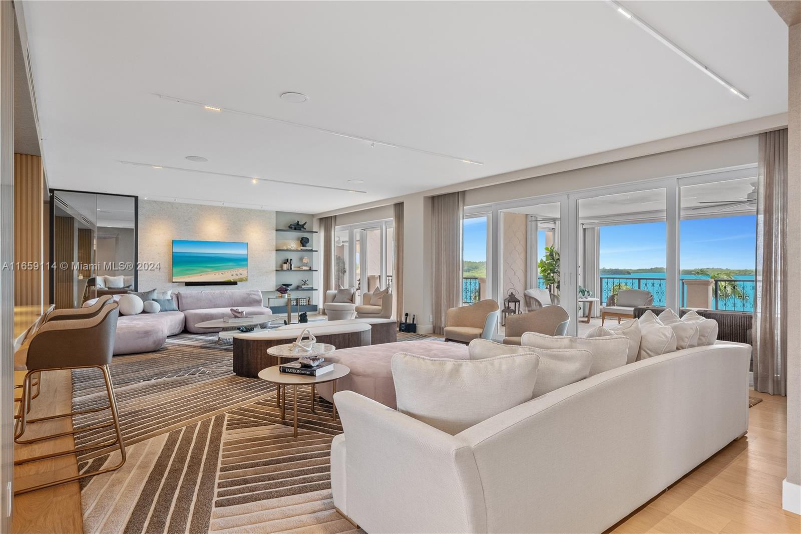 a living room with furniture large window and a wooden floor