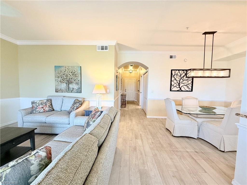 a living room with furniture and painting on the wall