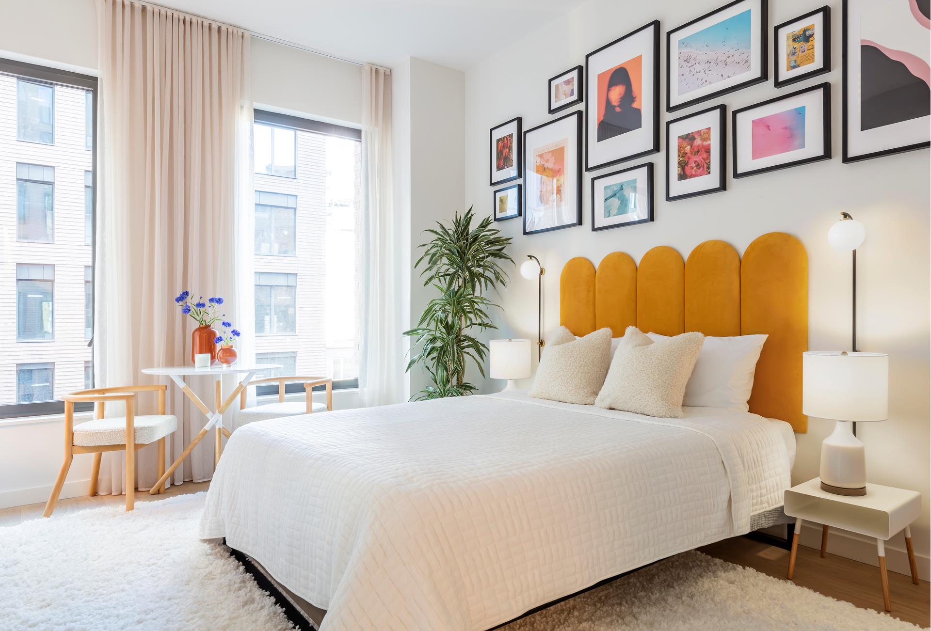 a bedroom with a bed and a painting on the wall