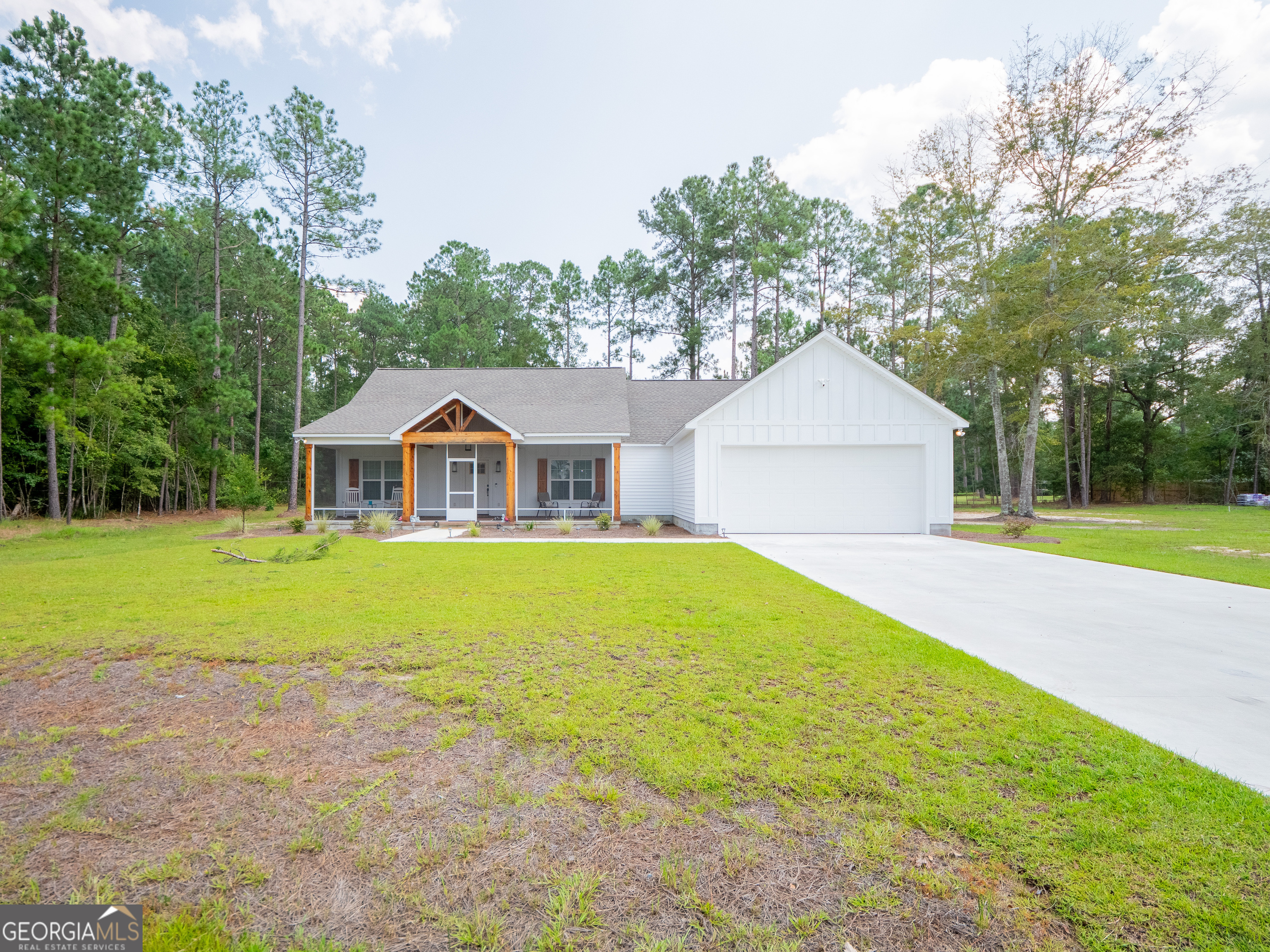 a front view of house with swimming pool and green space