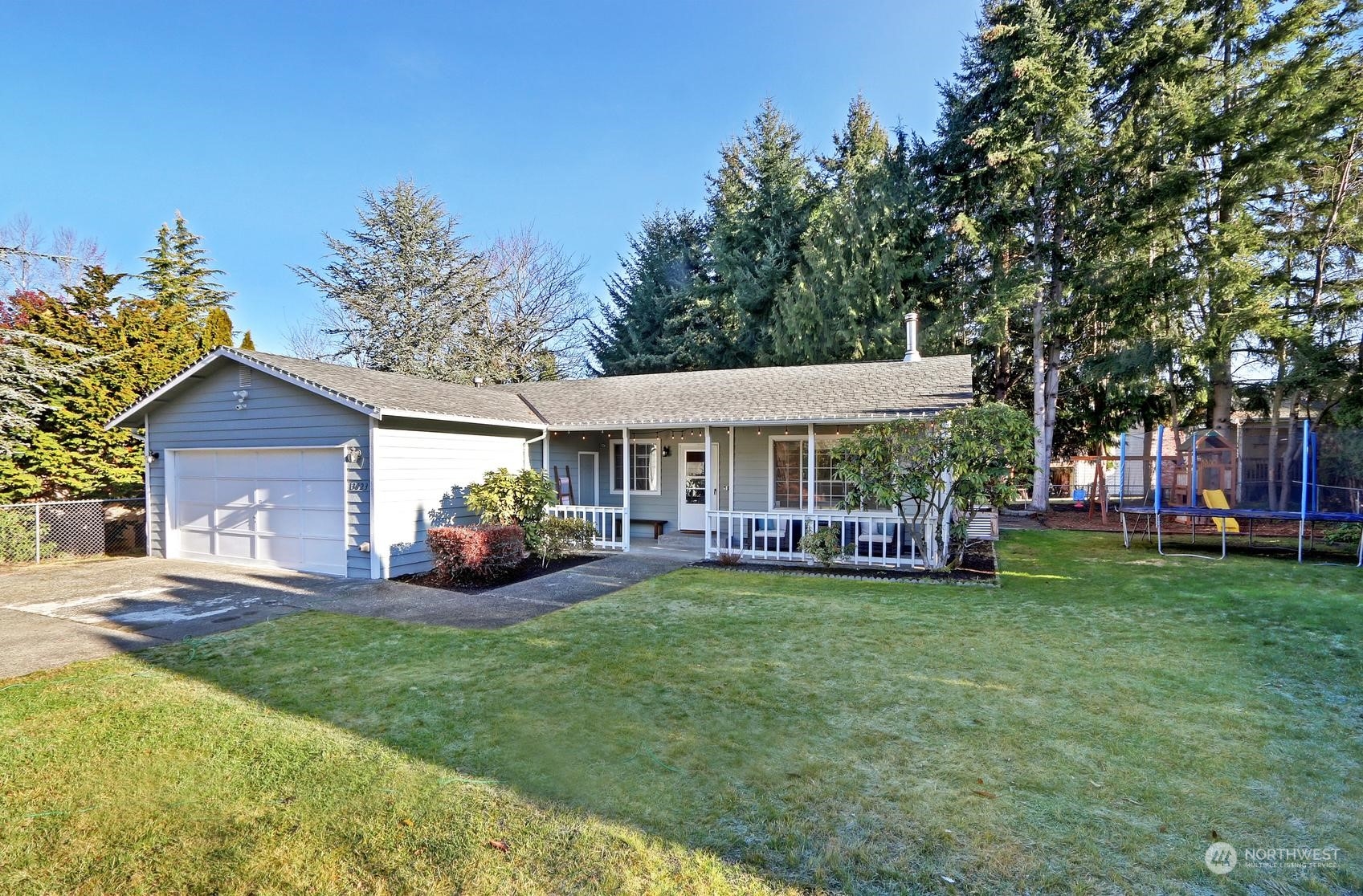 a view of a house with a yard and sitting area