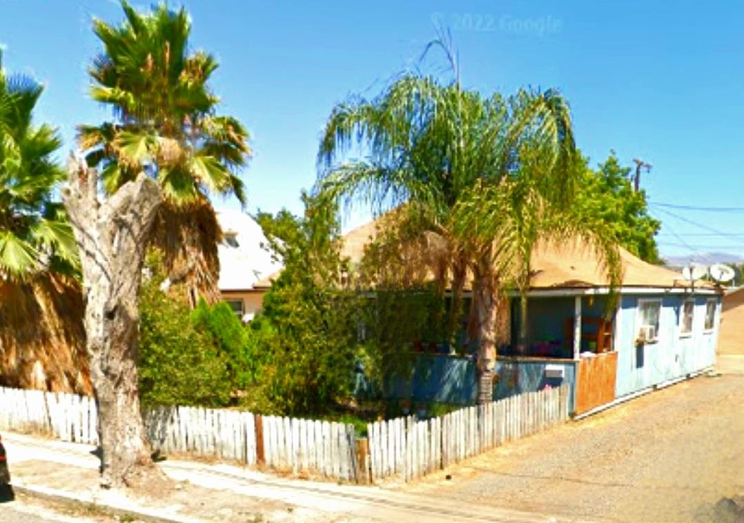 a view of a house with palm tree in front of it