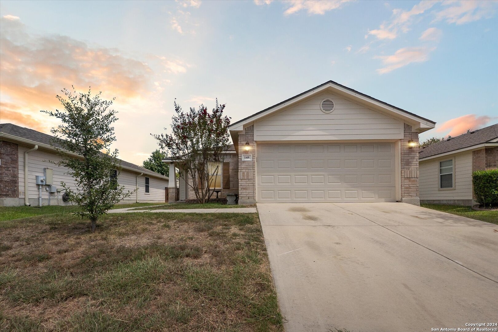 a front view of a house with a yard and garage