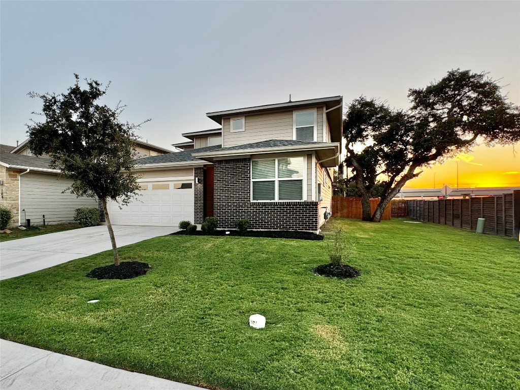 a view of backyard of house with green space