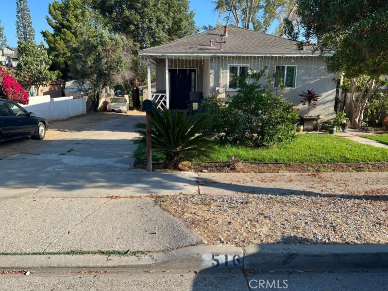 a view of a house with a yard and tree s