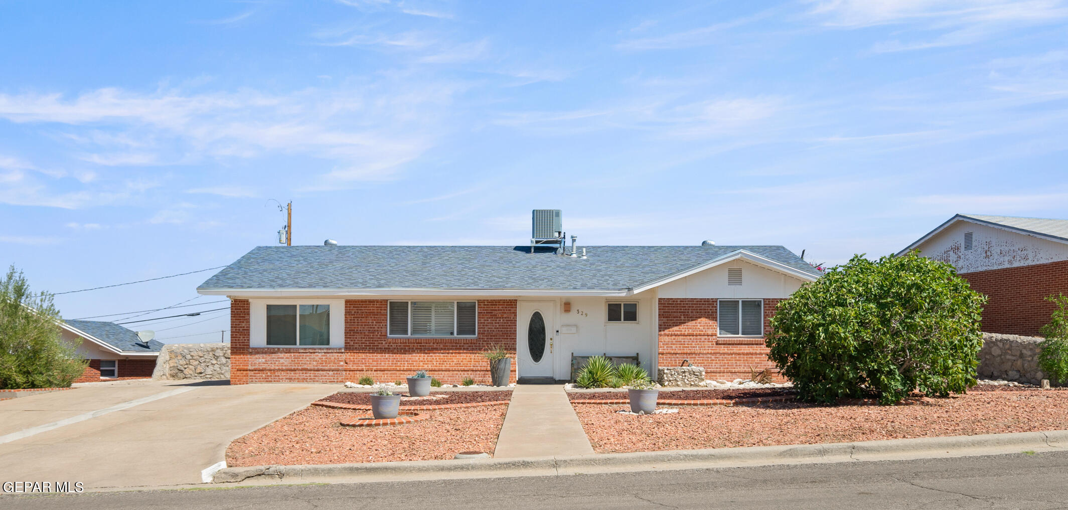 a front view of a house with a garden