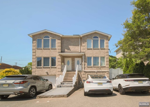 a front view of a house with parking space