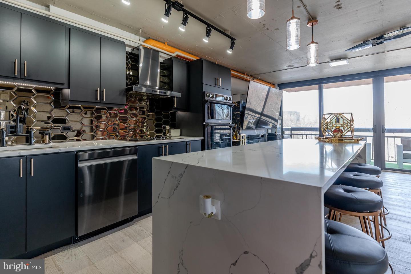 a kitchen with stainless steel appliances kitchen island granite countertop a stove and cabinets